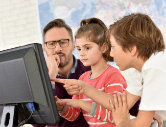 Teacher with kids on the computer
